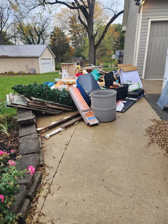 Dumpster being loaded with debris for Roofing Dumpster Rental in Fulton